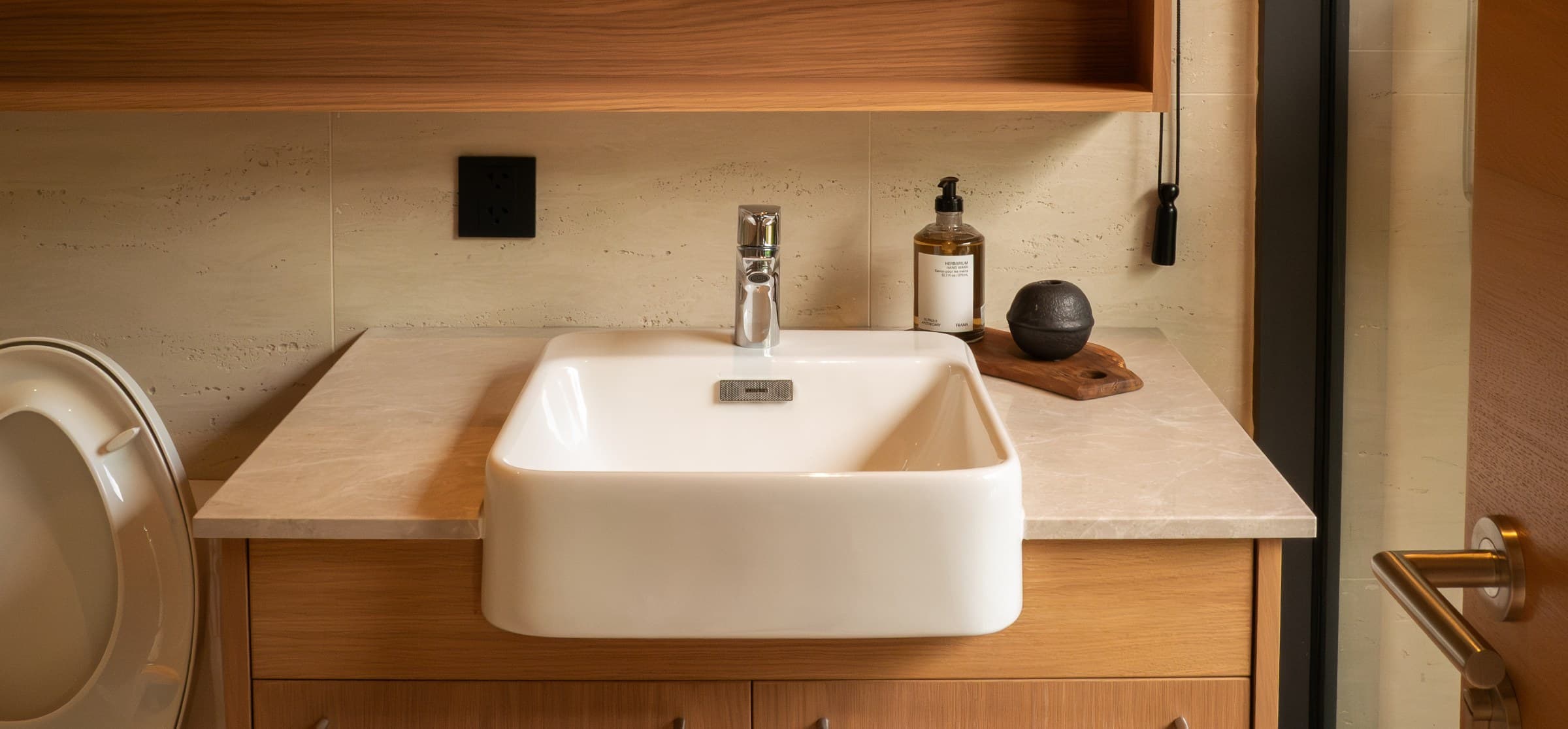 Sati bathroom with stone counter and a vessel basin